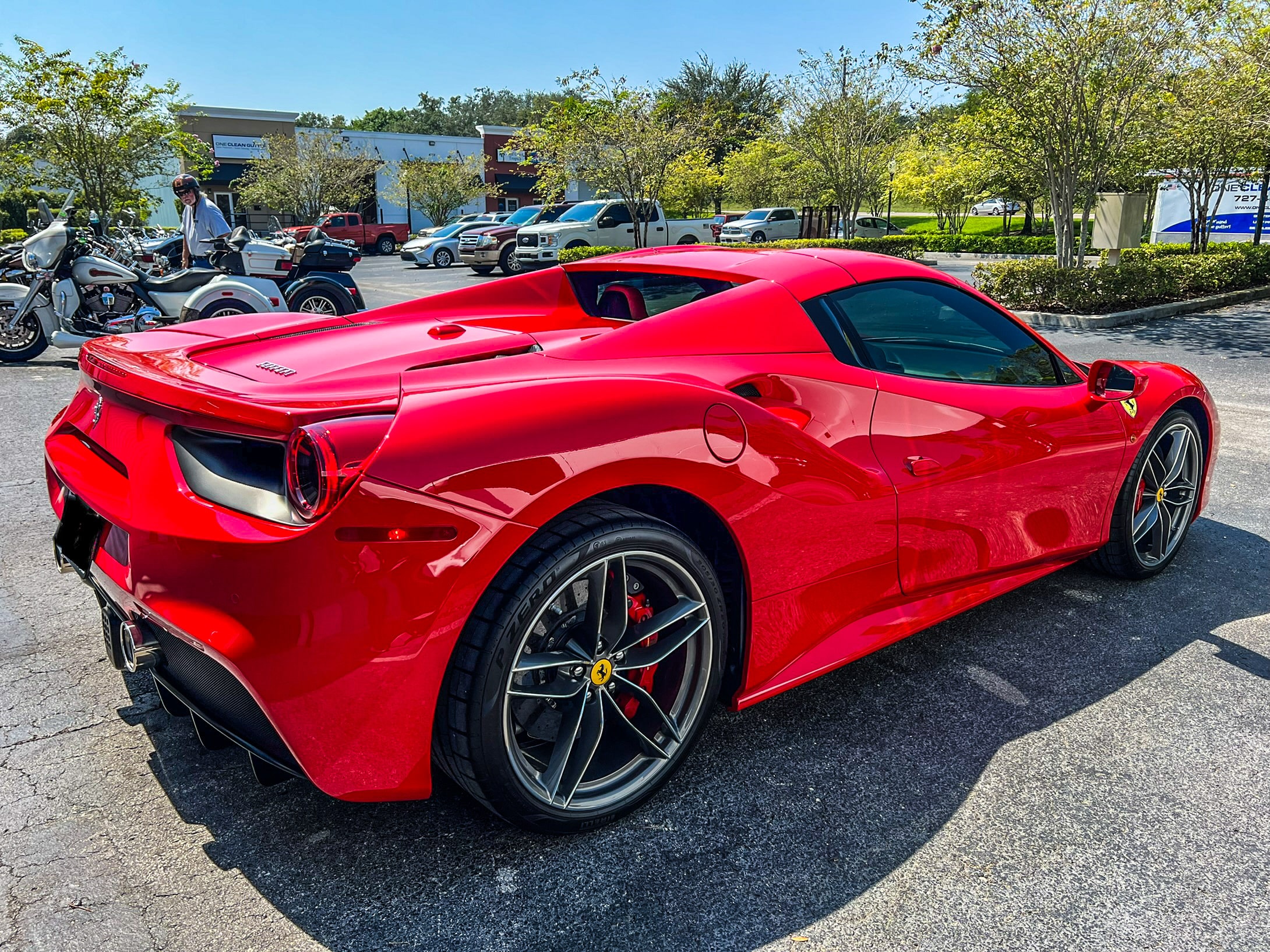 Red Ferrari 488 Spider with glossy PPF Tampa finish parked outdoors