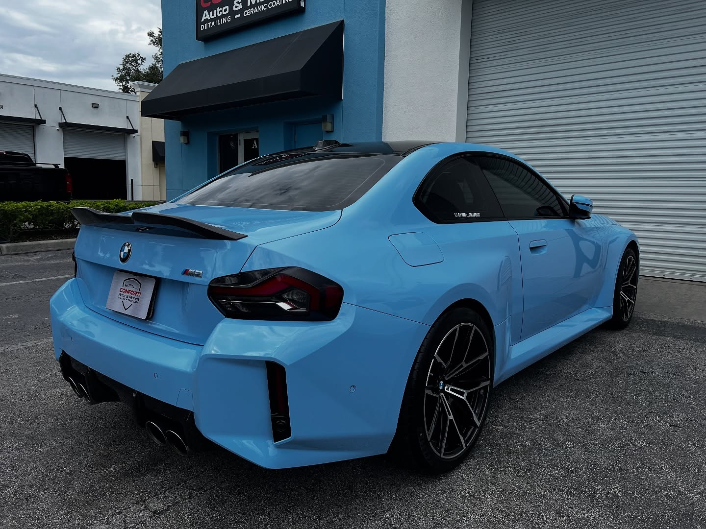Blue BMW M2 with glossy PPF finish parked outside Conforti Detailing