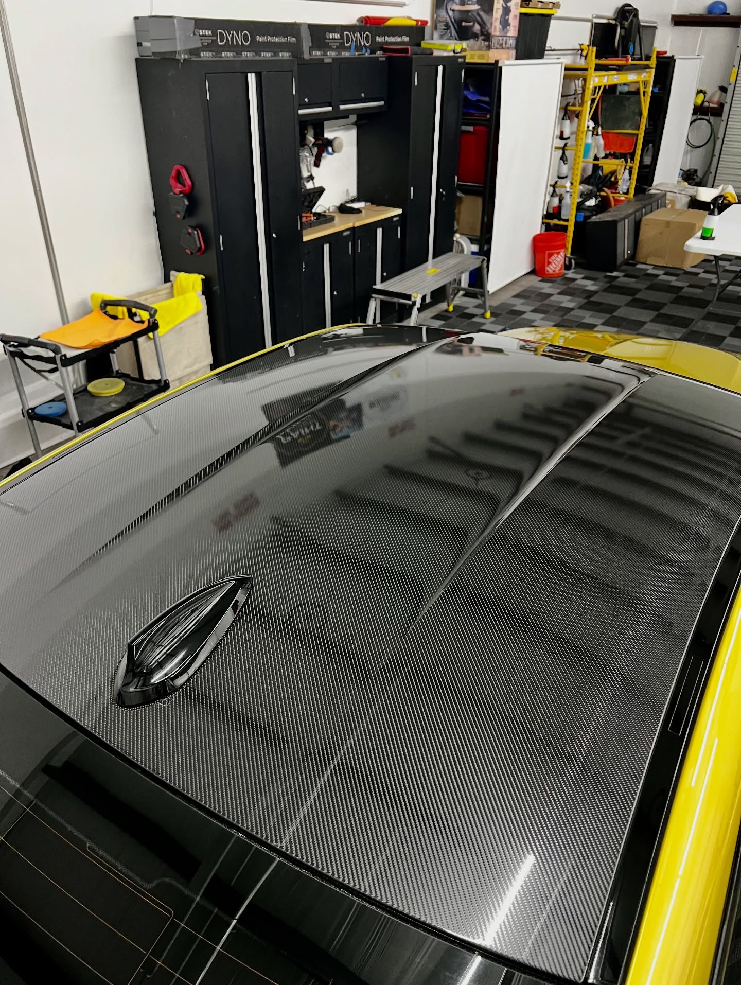 Gloss carbon fiber PPF on yellow car roof showing matte vs gloss PPF finish