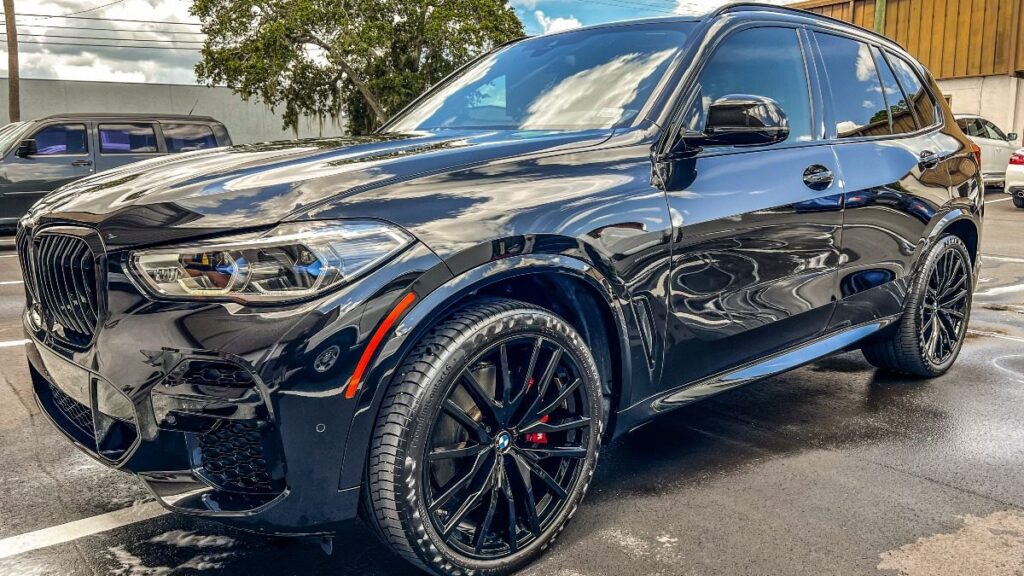 Black BMW SUV getting a professional ceramic coating at Conforti Auto & Marine Detailing