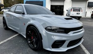White Dodge Charger during paint correction before ceramic coating at Conforti Auto & Marine Detailing