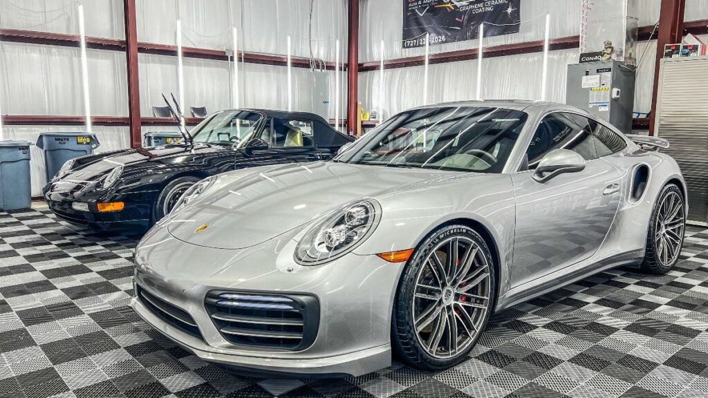 Silver Porsche 911 Turbo in the Conforti Auto & Marine Detailing bay after paint protection film installation in Palm Harbor, FL